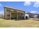 Backyard featuring a covered patio, grill, seating, shed, level yard, and trampoline at 5761 Sawgrass Cir, Lithonia, GA 30038