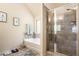 Bright bathroom features a soaking tub, a glass-enclosed shower, and neutral-toned tile work at 5761 Sawgrass Cir, Lithonia, GA 30038