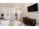 Comfortable bedroom featuring a large bed, TV, dresser, and ensuite bathroom at 5761 Sawgrass Cir, Lithonia, GA 30038