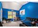 Bright blue room with high ceilings and large window offers ample storage and an inspirational space at 5761 Sawgrass Cir, Lithonia, GA 30038