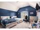 Upstairs bedroom features vaulted ceiling, two twin beds, gaming chair, and custom blue paint at 5761 Sawgrass Cir, Lithonia, GA 30038