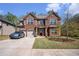 Inviting two-story brick home featuring a well-manicured lawn, a two-car garage, and a welcoming facade at 5761 Sawgrass Cir, Lithonia, GA 30038