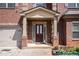 Close-up of the front entrance with a brick facade and a covered porch with supporting columns at 5761 Sawgrass Cir, Lithonia, GA 30038