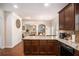 Gourmet kitchen with a center island, granite countertops, dark wood cabinetry, and hardwood floors at 5761 Sawgrass Cir, Lithonia, GA 30038