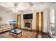 Comfortable living room featuring a stone fireplace, a ceiling fan, and stylish decor at 5761 Sawgrass Cir, Lithonia, GA 30038