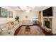 Spacious living room featuring a stone fireplace, a ceiling fan, and a large area rug at 5761 Sawgrass Cir, Lithonia, GA 30038