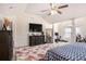 Large main bedroom boasts a king bed, dresser, mirror, TV, and an adjacent office/workout area at 5761 Sawgrass Cir, Lithonia, GA 30038