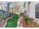 A long, narrow stone path leads through the landscaped backyard to outdoor seating at 2516 Woolwich Nw Ct, Acworth, GA 30101