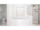 Bright bathroom features a large soaking tub, a window, and a glass-enclosed shower with gold trim at 2516 Woolwich Nw Ct, Acworth, GA 30101