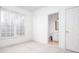 Empty bedroom with bright window, neutral carpet and an attached bathroom at 2516 Woolwich Nw Ct, Acworth, GA 30101