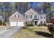 Traditional brick home boasts an attached two-car garage and a manicured front lawn at 2516 Woolwich Nw Ct, Acworth, GA 30101