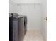 Laundry room with gray washer and dryer units and tile flooring at 2516 Woolwich Nw Ct, Acworth, GA 30101