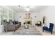 Well-lit living room featuring modern decor and a cozy fireplace at 2516 Woolwich Nw Ct, Acworth, GA 30101