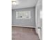 Neutral bedroom features a large window that lets in natural light and light gray walls at 2520 Robin Hood Ne Pl, Marietta, GA 30068