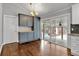 Dining area featuring modern cabinets, hardwood floors, and access to the backyard at 2520 Robin Hood Ne Pl, Marietta, GA 30068