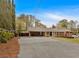 Brick home with an attached carport and a charming, well-kept front yard and brick driveway at 2520 Robin Hood Ne Pl, Marietta, GA 30068