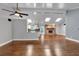 Open-concept living room featuring hardwood floors, a brick fireplace, skylights, and a seamless transition into the kitchen at 2520 Robin Hood Ne Pl, Marietta, GA 30068