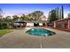 Beautiful backyard pool with deck, lounge chairs, and landscaped yard with tall trees at 2520 Robin Hood Ne Pl, Marietta, GA 30068