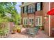 Charming brick patio with outdoor seating, surrounded by lush greenery and the home's elegant brick exterior at 978 Moores Club Ne, Atlanta, GA 30319