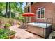 Relaxing outdoor patio featuring a hot tub, comfortable seating, and a stylish red umbrella, perfect for entertaining at 978 Moores Club Ne, Atlanta, GA 30319