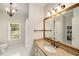 Bright bathroom with a large mirror, granite counter, and tiled floors at 978 Moores Club Ne, Atlanta, GA 30319