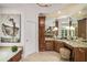 Spacious bathroom with dual granite vanities, a separate tub, and natural light at 978 Moores Club Ne, Atlanta, GA 30319