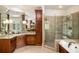 Bright bathroom featuring a glass shower, granite vanity, soaking tub, and tiled floors at 978 Moores Club Ne, Atlanta, GA 30319