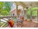 Relaxing covered porch with brick flooring, decorative railings, and outdoor furniture, perfect for enjoying the outdoors at 978 Moores Club Ne, Atlanta, GA 30319