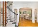 Elegant foyer with hardwood floors, staircase with dark wood trim, and open archway to the living room at 978 Moores Club Ne, Atlanta, GA 30319