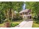 Stately two-story brick home featuring lush landscaping, mature trees, and a private driveway at 978 Moores Club Ne, Atlanta, GA 30319