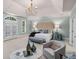 Serene main bedroom with a tufted headboard, soft lighting, and French doors leading to a private balcony at 978 Moores Club Ne, Atlanta, GA 30319
