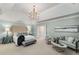 A spacious main bedroom features a sitting area, tray ceilings, a luxurious bed, and an elegant chandelier at 978 Moores Club Ne, Atlanta, GA 30319