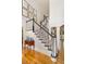 Elegant staircase with black and white railings, complemented by hardwood floors and decorative wall art at 978 Moores Club Ne, Atlanta, GA 30319