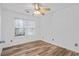 Bedroom featuring a ceiling fan, window with blinds, and light hardwood floors at 300 Lakeside Dr, Covington, GA 30016