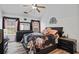 Bedroom with vaulted ceilings, a floral comforter, dresser, and bedside table at 300 Lakeside Dr, Covington, GA 30016