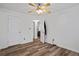 Spacious bedroom with ceiling fan, wood floor, and closet at 300 Lakeside Dr, Covington, GA 30016