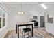 Dining area featuring a modern light fixture, table, and windows overlooking the backyard at 300 Lakeside Dr, Covington, GA 30016