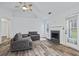 Spacious living room featuring a cozy fireplace and large windows overlooking the yard at 300 Lakeside Dr, Covington, GA 30016
