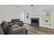 Bright living room with new flooring, a fireplace, and a door to the outdoors at 300 Lakeside Dr, Covington, GA 30016