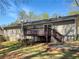 Backyard featuring a wooden deck with stairs down to a spacious lawn at 31 Fox Creek Ct, Dallas, GA 30157