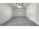 Bright bedroom featuring plush carpets, large window and a ceiling fan at 31 Fox Creek Ct, Dallas, GA 30157