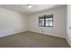 The bedroom has carpet flooring, a large window, and neutral-colored walls providing a calming atmosphere at 31 Fox Creek Ct, Dallas, GA 30157
