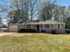 Charming single-story home featuring a covered porch, manicured landscaping, and attached garage at 31 Fox Creek Ct, Dallas, GA 30157