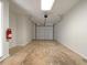 Spacious garage with garage door and fire extinguisher on the wall at 31 Fox Creek Ct, Dallas, GA 30157