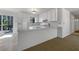 Bright kitchen with white cabinets, long countertop, neutral flooring, and access to the rear deck at 31 Fox Creek Ct, Dallas, GA 30157