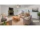Bright, staged living room features a stone fireplace, neutral decor, and seamless flow to the kitchen at 31 Fox Creek Ct, Dallas, GA 30157