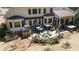 A backyard offers a stone patio with a fire pit, an outdoor kitchen, a hot tub, and ample space for entertaining at 3227 Aviary Nw Ct, Acworth, GA 30101