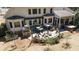 Wide view of backyard with patio, outdoor kitchen, and screened-in porch and mature trees at 3227 Aviary Nw Ct, Acworth, GA 30101