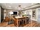 Finished basement with hardwood floors, a leather couch, entertainment center, and a wooden table with stools at 3227 Aviary Nw Ct, Acworth, GA 30101