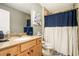 Charming guest bathroom with a vanity sink and tiled shower with a stylish curtain at 3227 Aviary Nw Ct, Acworth, GA 30101